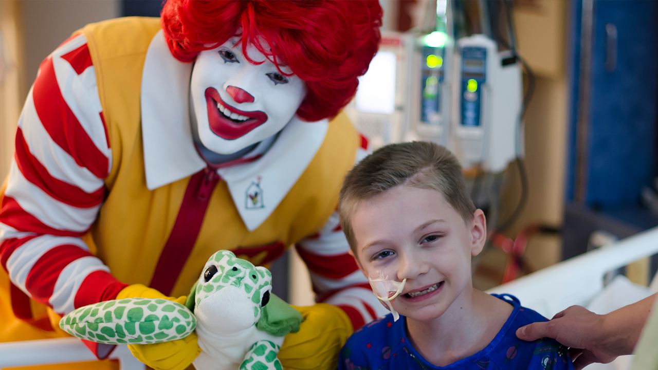 Ronald McDonald visiting a young patient